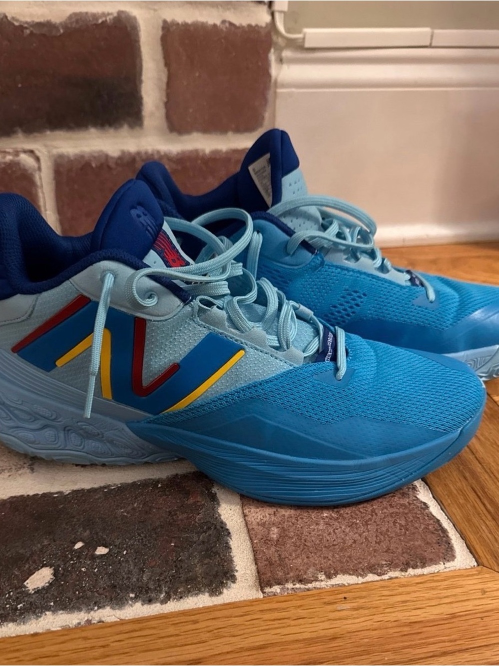 New Balance Blue Athletic Sneakers with Navy, Red & Yellow Accents